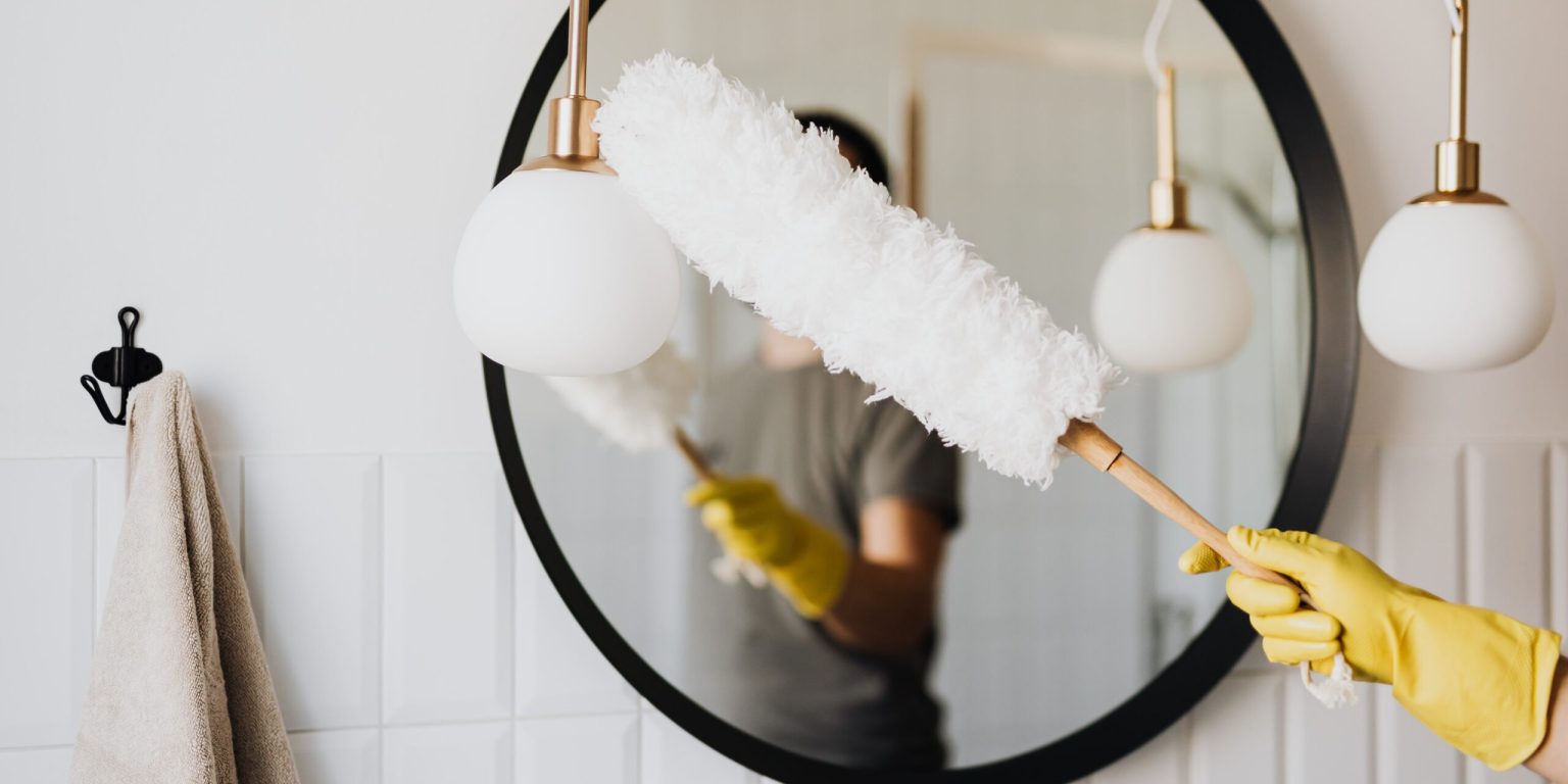 Woman Cleaning Bathroom to get her home ready for a sale